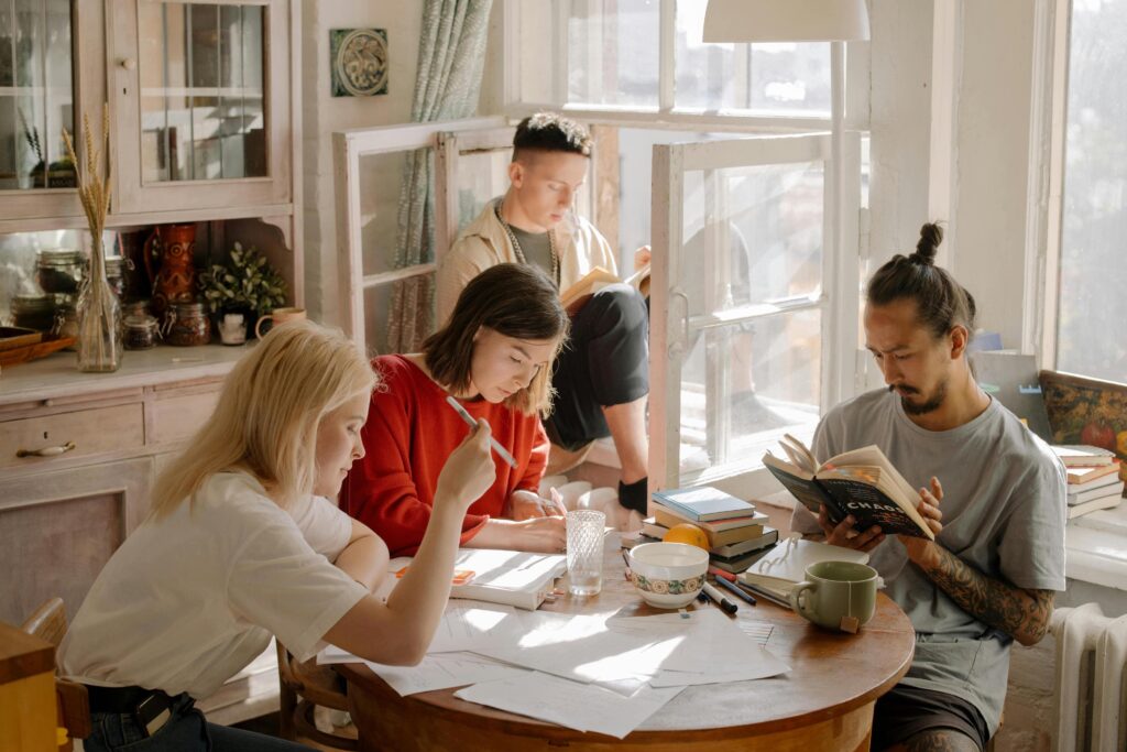 Group of people reading and writing together at home